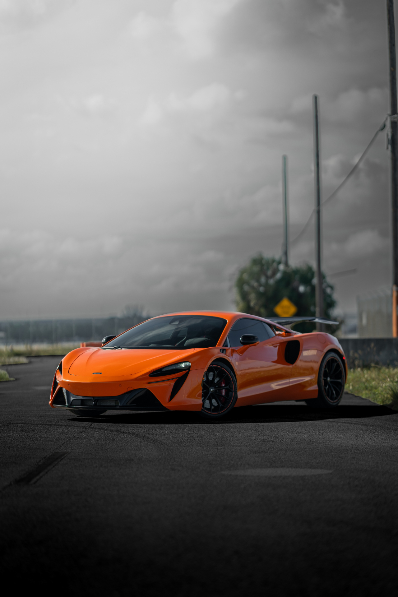 Orange McLaren Artura on an open road