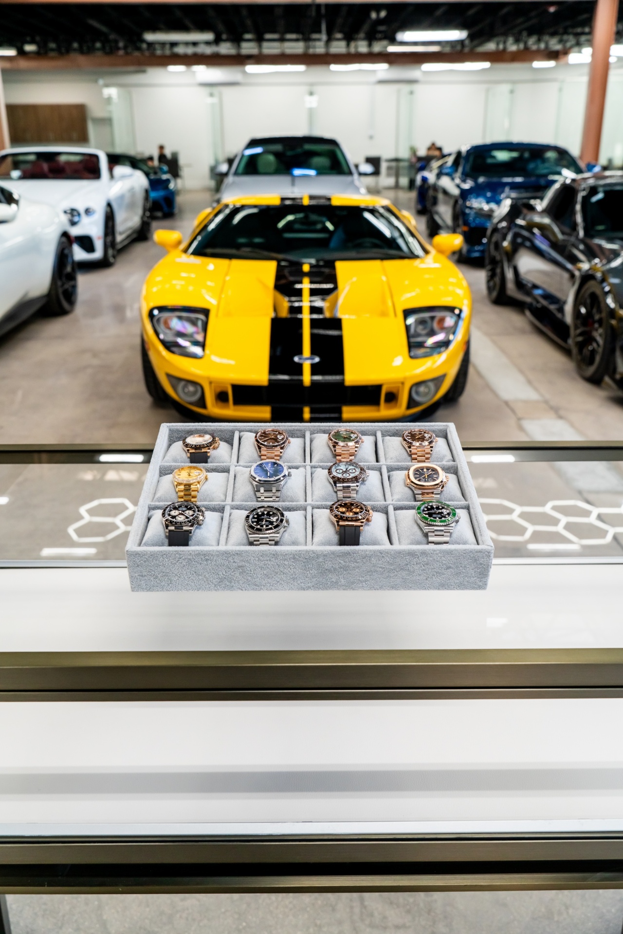 Yellow Ford GT with luxury watch collection